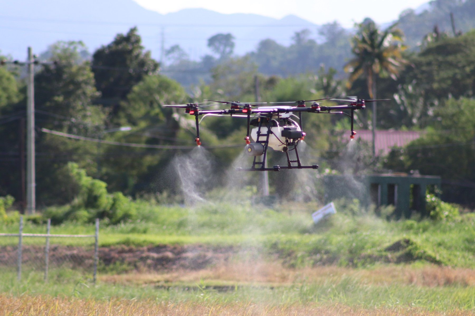 Agricultural spray drone over a field